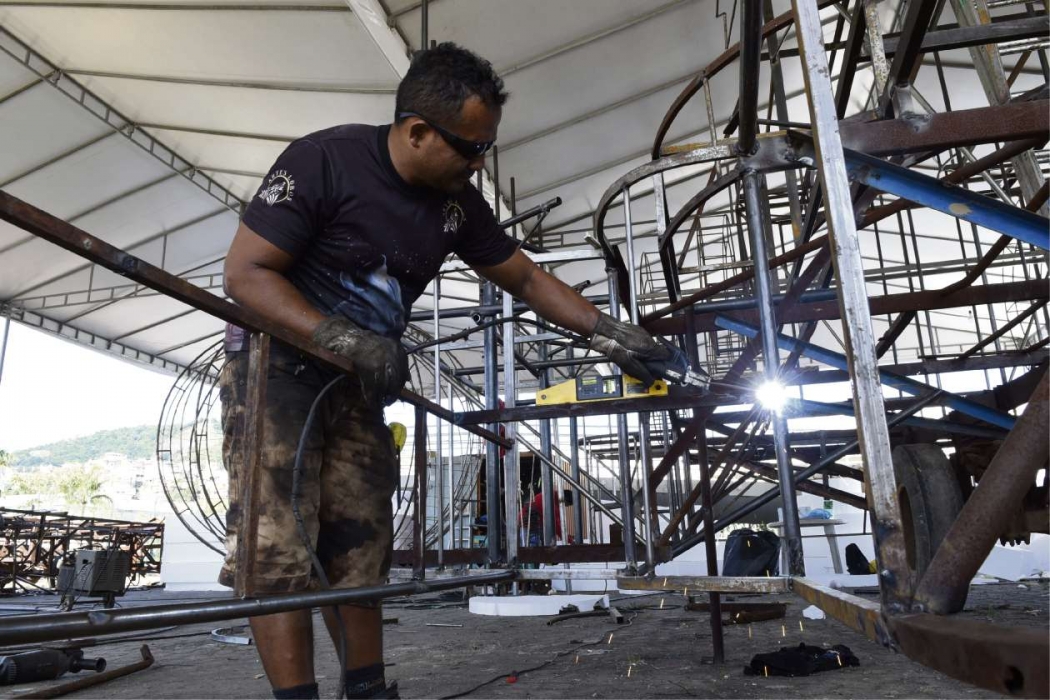Soldadores artísticos trabalham na estrutura inicial do carro alegórico da Boa Vista